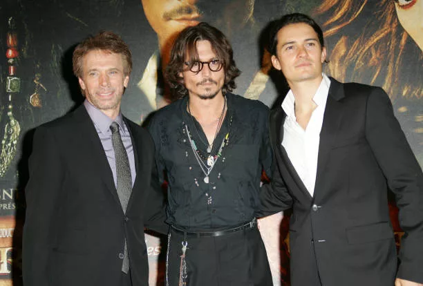 Jerry Bruckheimer, Johnny Depp and Orlando Bloom during "Pirates of The Caribbean: Dead Man's Chest" Paris Premiere at Gaumont Marignan Theater in...